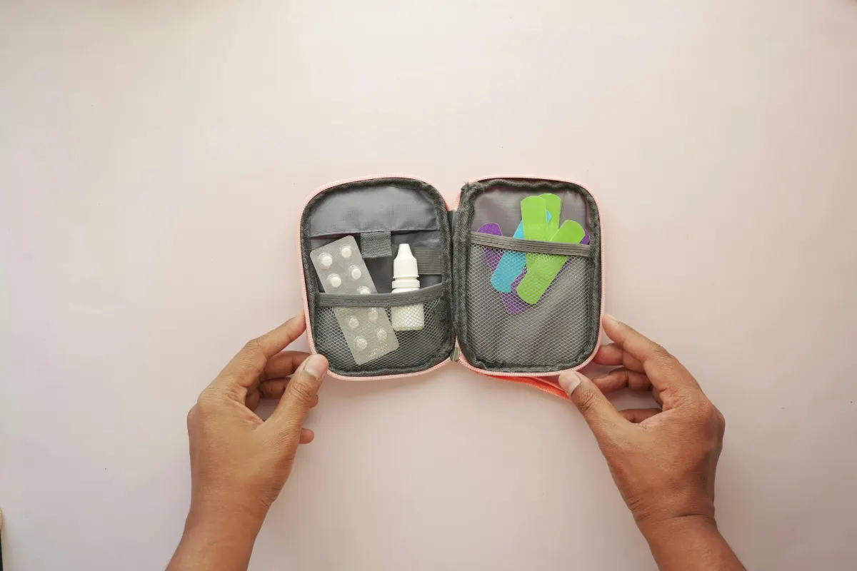 small first aid kit in a pouch by a person