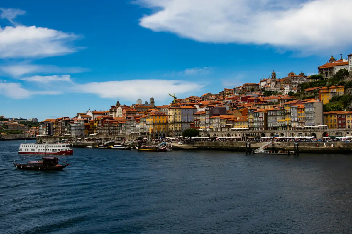 Harbour view showcasing watercrafts, city architecture, church, sailboat and ferry in a sea town