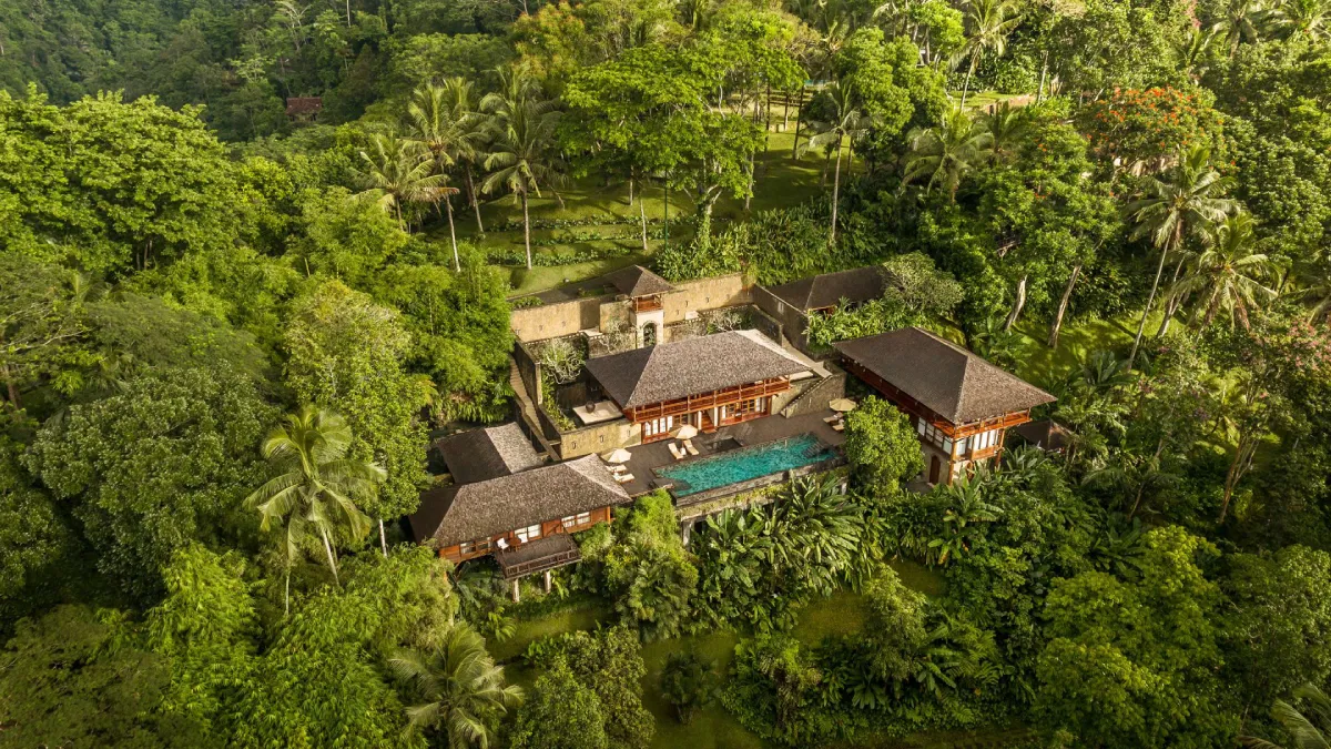 Quaint wooden cabin nestled amongst lush greenery under a serene sky