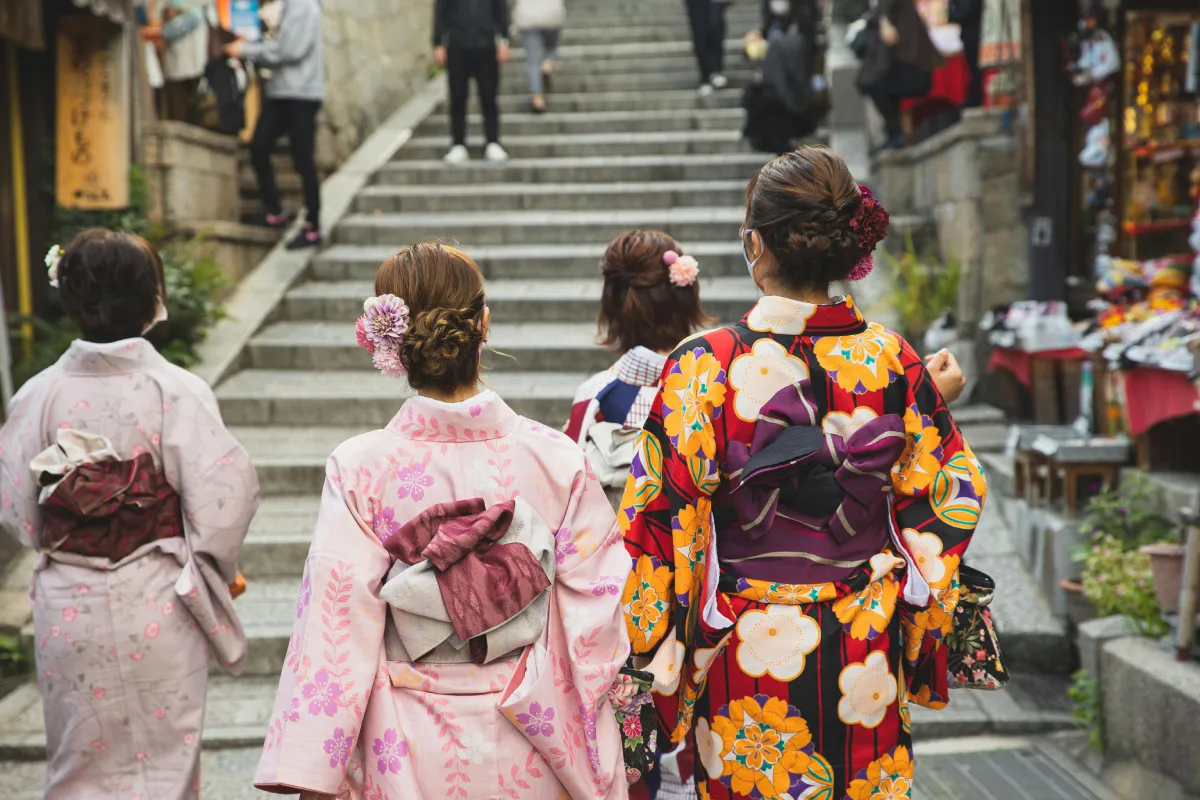 Group of people in traditional Geisha and Kimono costumes during a Matsuri street festival