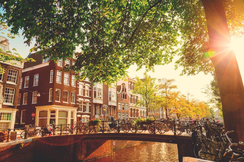 Old town architecture alongside a peaceful urban canal, perfect for summer family tourism