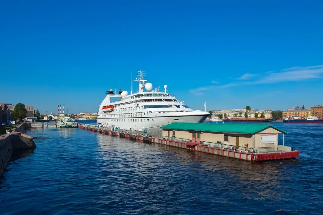 Luxury cruise ship in a harbour, ready for an ocean voyage under a clear sky