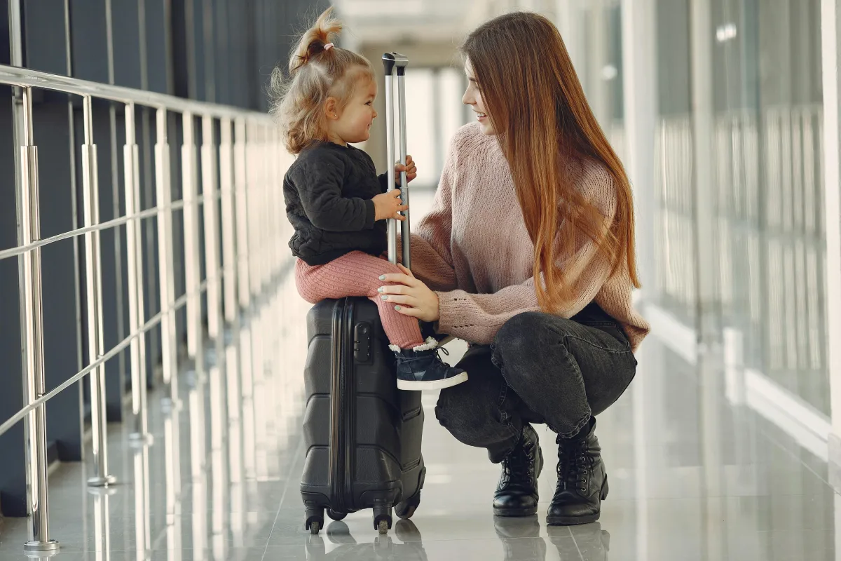 Loving mother and adorable son packing luggage as a family for a fun outdoor trip