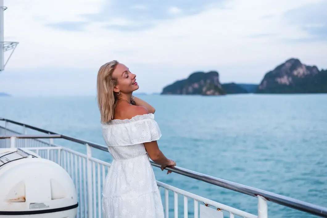 Woman enjoying leisurely summer vacation, relaxing amidst sea under sunny blue sky