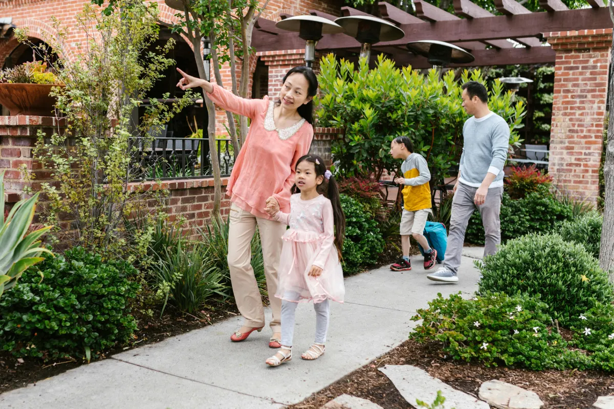 Woman and child enjoying a sunny day in a colourful flower garden