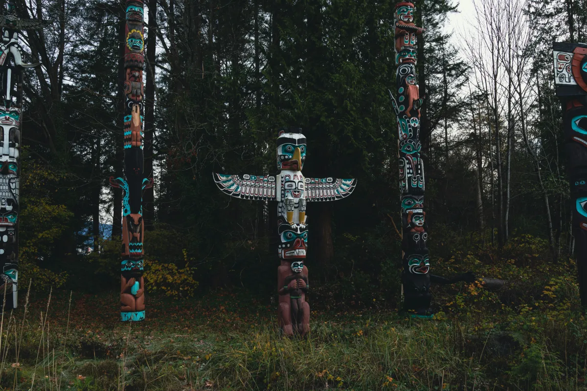 A colourful West-Coast totem pole featuring the image of a bird and outstretched wings.